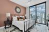 Spacious bedroom suite with high ceilings.