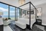 Primary suite with floor-to-ceiling glass walls.