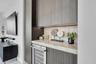 Custom cocktail bar niche with stone counters.