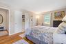 Bedroom with wood finished floors and baseboards