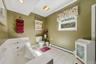 White tile flooring, built-in soaking tub, single window, recessed ceiling lighting, and a white toilet