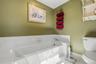 White tile flooring and bathtub surround