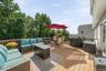 Spacious outdoor deck with wood railing, offering expansive open-air living