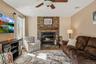 Stone fireplace featuring a wood mantel