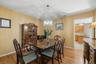 Hardwood flooring throughout featuring a decorative chandelier