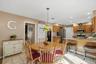 Kitchen featuring wood cabinetry, stainless steel appliances, and a tiled backsplash