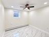 Recessed lighting, ceiling fan, single window, baseboard heating, and tile flooring with a marble-like pattern