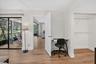 Wood-finish flooring throughout, with a desk area and wall closet