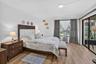 Wood-finish flooring, white walls, and sliding glass doors to the Florida room