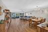 Expansive main living area featuring wood-finish flooring, and a contemporary chandelier