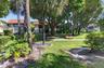 Manicured lawn with mature trees and tropical landscaping