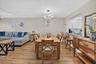 Wood-finish flooring throughout, complemented by a modern chandelier