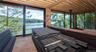 Materials already on site include the exterior siding, stained and ready for installation, as well as stone façade materials for portions of the lower