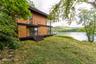 This is a virtually enhanced photo of how the home can look finished. From the dining area, access to the side yard, where plans envision an outdoor k