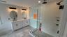 Additional view of the generous-spa like primary bath with newly glass enclosed walk in shower glass and tile.