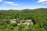 Drone / aerial view of a forest and a mountainous background