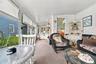 Enjoy your days relaxing overlooking gardens from walls of windows in sunroom.