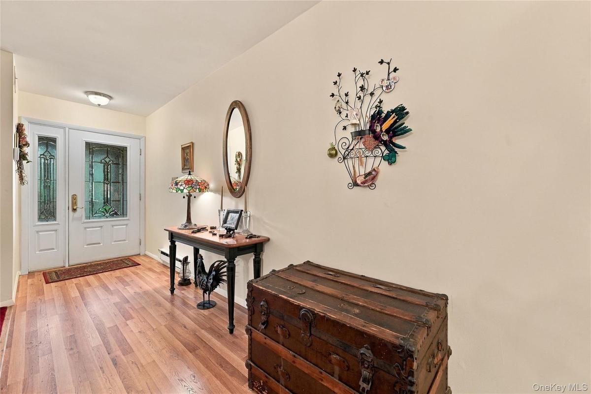 Entrance foyer area with Laminate wood flooring and beautiful door.