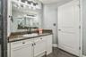 Primary bathroom with dual vanities.