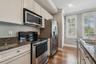 Kitchen featuring stainless steel appliances, and stone countertops.