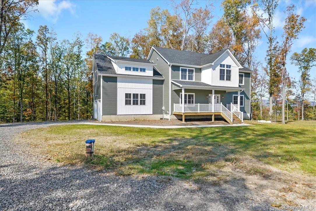 View of front of property featuring a front lawn and a porch