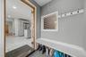 Entryway featuring built-in bench seating, storage cubbies, and wall-mounted coat hooks