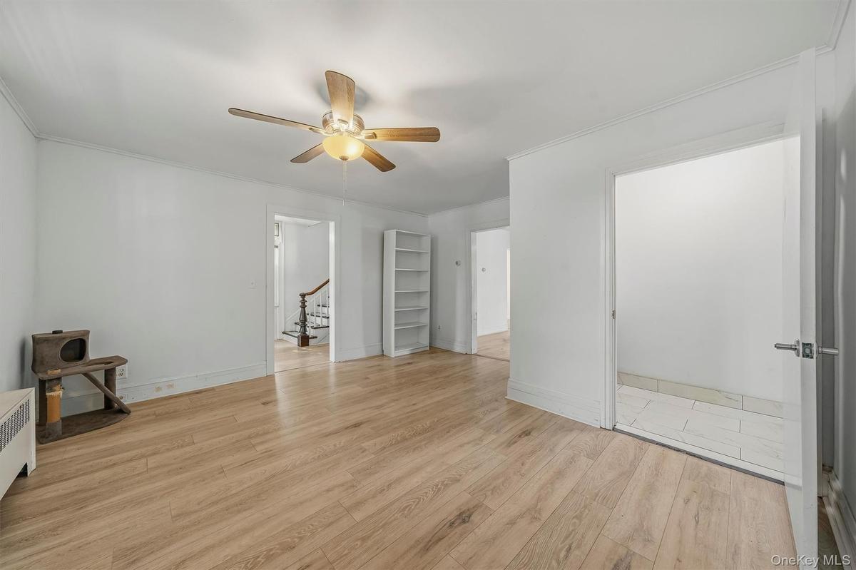 Additional view of the office highlighting the generous floor space and adjoining rooms.