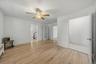 Additional view of the office highlighting the generous floor space and adjoining rooms.