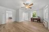 Spacious office with multiple windows, ceiling fan, and plenty of natural light.