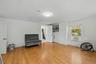 Wood-finish flooring with white walls and a built-in storage cabinet