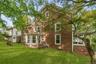 Brown clapboard siding with white trim
