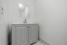 Freestanding vanity with panel cabinetry and brushed nickel hardware