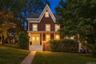 Architectural facade featuring a prominent gable roof and rich siding