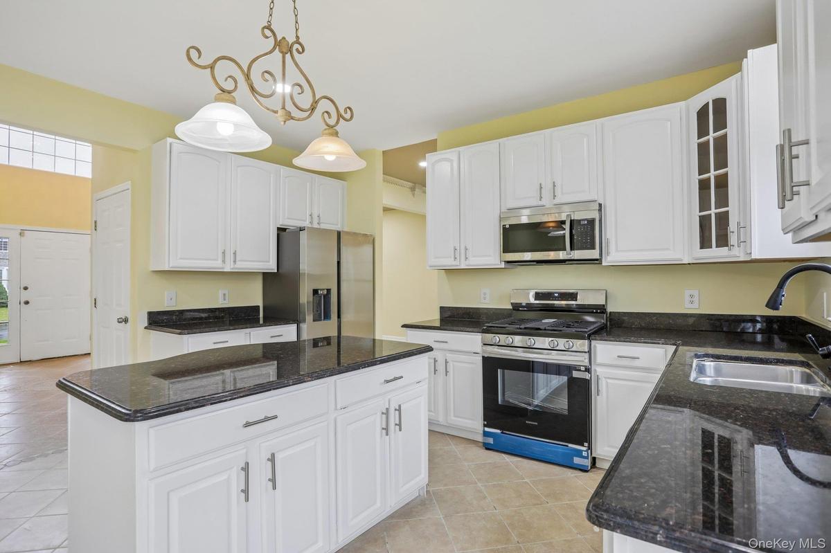 Granite countertops, wood cabinets with new hardware