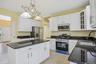 Granite countertops, wood cabinets with new hardware