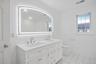 Brand new dual-sink cabinet, mirror and new toilet