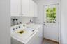 Main level laundry room with door to deck