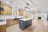 Kitchen featuring light hardwood / wood-style floors, plenty of natural light, sink, and a center island