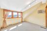 Carpeted spare room with rail lighting and an AC wall unit