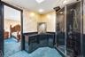 Ensuite bathroom with vanity, a stall shower, recessed lighting, and concrete floors