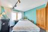 Bedroom with dark carpet and track lighting