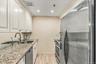 Updated Galley Kitchen with Stainless Steel Appliances
