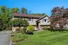 3 Bedroom home featuring stone and siding exterior, a brown shingle roof, and a paved driveway