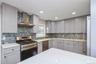 First floor renovated kitchen with quartz counter tops and stainless steel appliances.