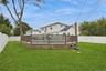Yard spaces around permitted partially inground pool with fence and trek decking surrounding