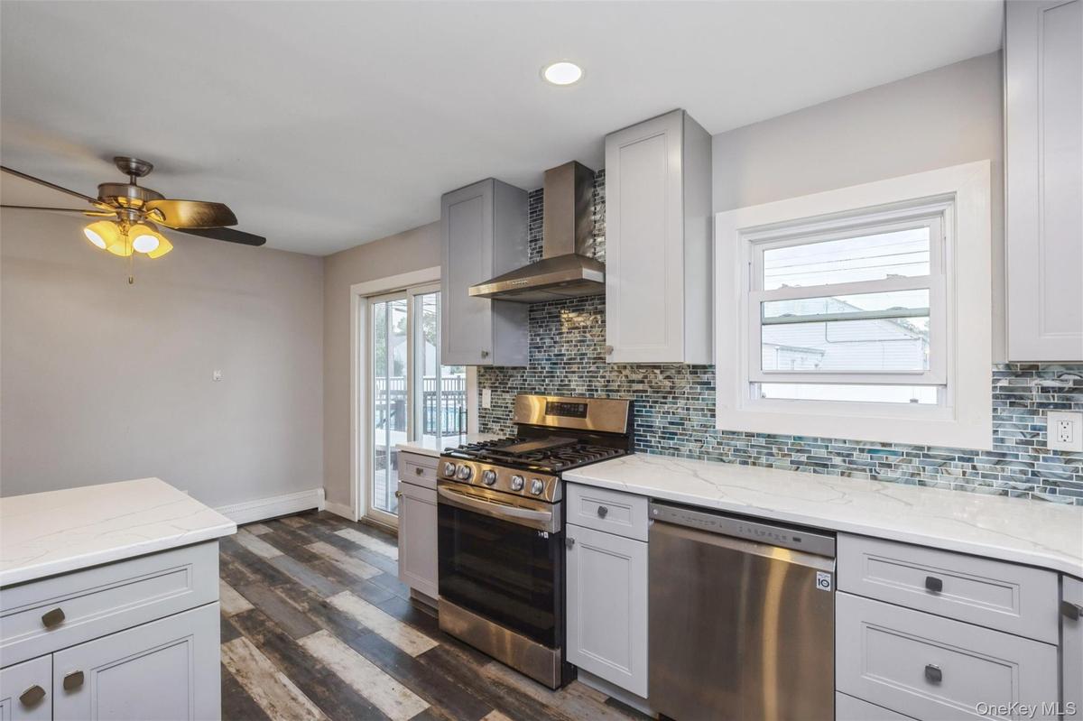 First floor renovated kitchen with quartz counter tops and stainless steel appliances.