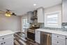 First floor renovated kitchen with quartz counter tops and stainless steel appliances.