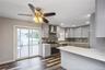 First floor renovated kitchen with quartz counter tops and stainless steel appliances. Sliders to deck in yard.
