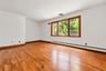 BR 3.  Oversized windows. Wood floors. Extraneous objects removed from photo.