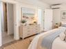 Primary bedroom with entrance to large walk-in closet and primary bath